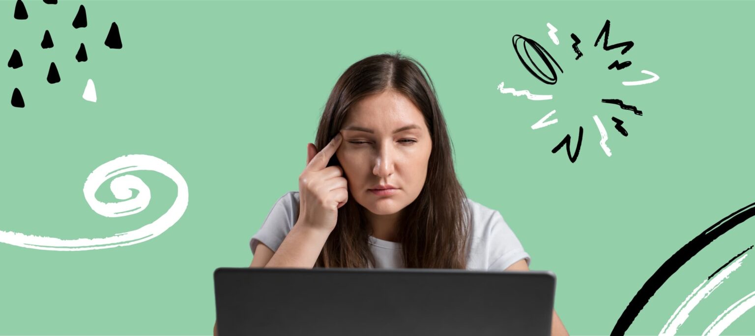 computer vision syndrome woman working on laptop touching her eye